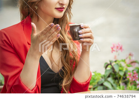 Beautiful young woman sniffing coffee 74638794
