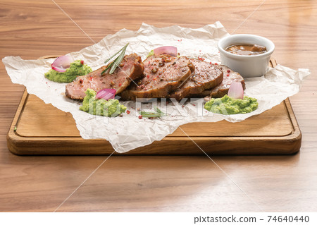 Roast pork with pea puree and sauce 74640440