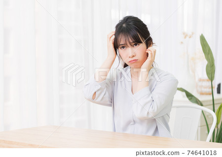 Young woman thinking in the room Young woman thinking in the room 74641018