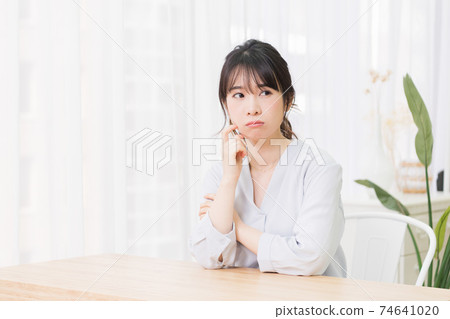 Young woman thinking in the room Young woman thinking in the room 74641020