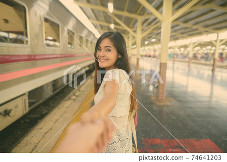 Young beautiful Asian tourist woman at the railway station in Bangkok, Thailand Young beautiful Asian tourist woman at the railway station in Bangkok, Thailand 74641203
