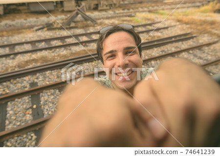 Handsome Persian tourist man at the railway station in Bangkok, Thailand 74641239
