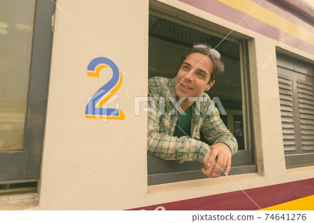 Handsome Persian tourist man at the railway station in Bangkok, Thailand 74641276