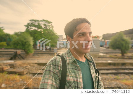 Handsome Persian tourist man at the railway station in Bangkok, Thailand 74641313