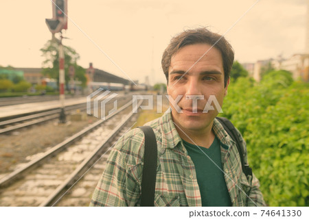 Handsome Persian tourist man at the railway station in Bangkok, Thailand 74641330