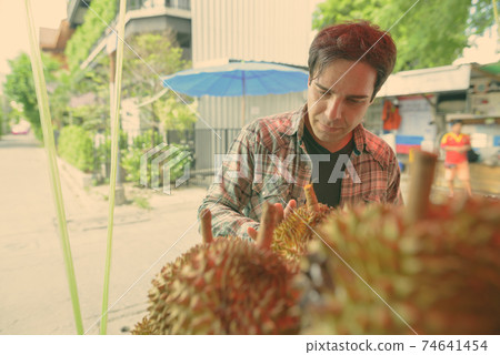 Handsome Persian tourist man exploring the city of Bangkok, Thailand 74641454