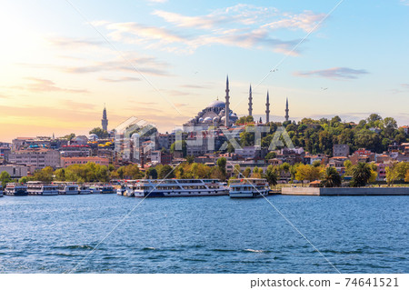 Eminonu Pier near the Suleymaniye Mosque in Istanbul, view from the Bosphorus at sunset Eminonu Pier near the Suleymaniye Mosque in Istanbul, view from the Bosphorus at sunset 74641521