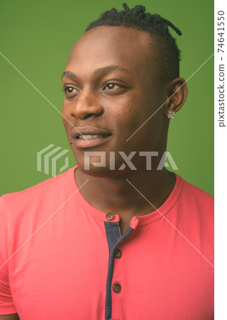 Young handsome African man from Kenya against green background 74641550