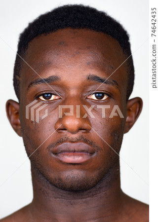 Face of young African man looking at camera Face of young African man looking at camera 74642435