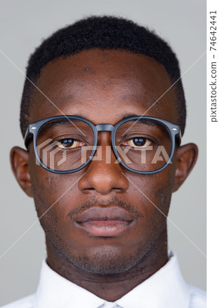 Face of young African businessman with eyeglasses Face of young African businessman with eyeglasses 74642441