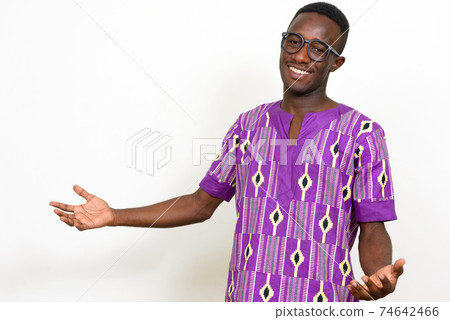 Portrait of happy young African man in traditional clothing 74642466