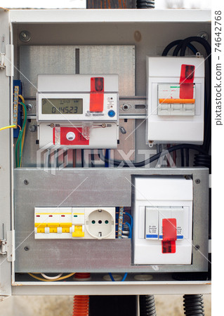 An introductory machine and an electric energy meter in a dashboard on a pole close-up An introductory machine and an electric energy meter in a dashboard on a pole close-up 74642768