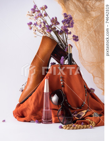 Fashion still life with shoes, sunglasses, accessories, shirt and dried flowers Fashion still life with shoes, sunglasses, accessories, shirt and dried flowers 74642819