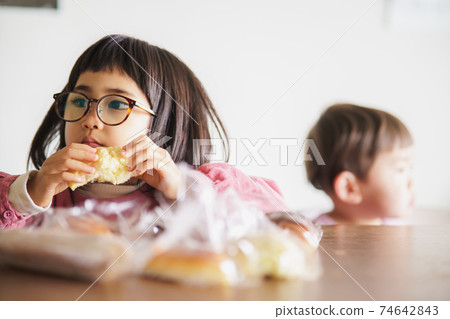 Child cheeking bread 74642843
