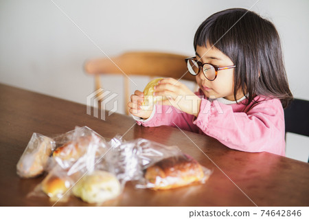 Child cheeking bread 74642846