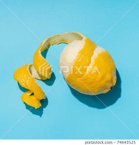 Lemon and spiral peel on blue background hardlight Lemon and spiral peel on blue background hardlight 74643525