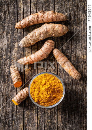 Indian turmeric powder and root. Turmeric spice. Ground turmeric. Indian turmeric powder and root. Turmeric spice. Ground turmeric. 74643943
