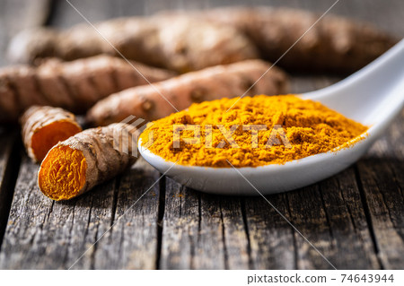 Indian turmeric powder and root. Turmeric spice. Ground turmeric. Indian turmeric powder and root. Turmeric spice. Ground turmeric. 74643944