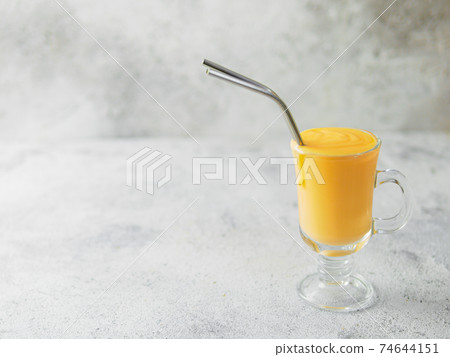 Yellow milkshake with metal straws, sopy space 74644151
