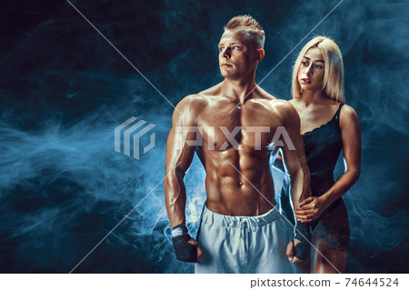 Attractive couple, a slim blonde female and handsome shirtless g Attractive couple, a slim blonde female and handsome shirtless g 74644524