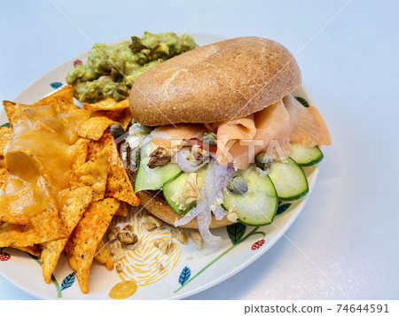 Smoked salmon sizzle cut that sticks out of the bagel sand 74644591