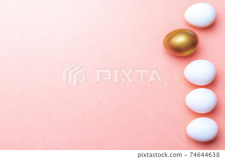 Easter message. Golden, white colour egg on pastel pink background in Happy Easter decoration. Foil minimalist egg design, modern top view template. 74644638