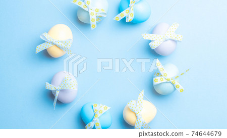 Easter set. Colorful egg with tape ribbon on pastel blue background in Happy Easter decoration. Traditional design with copy space. Easter set. Colorful egg with tape ribbon on pastel blue background in Happy Easter decoration. Traditional design with copy space. 74644679
