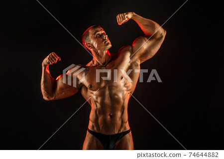 Portrait of shirtless muscular man with arm up Portrait of shirtless muscular man with arm up 74644882