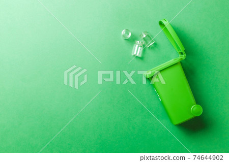 Bin icon. Container for disposal garbage waste and save environment. Green dustbin for recycle glass can trash isolated on green background. Bin icon. Container for disposal garbage waste and save environment. Green dustbin for recycle glass can trash isolated on green background. 74644902