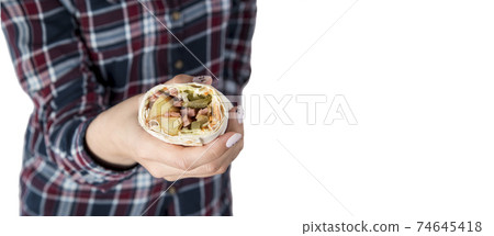 Female hands hold doner kebab, shawarma Female hands hold doner kebab, shawarma 74645418