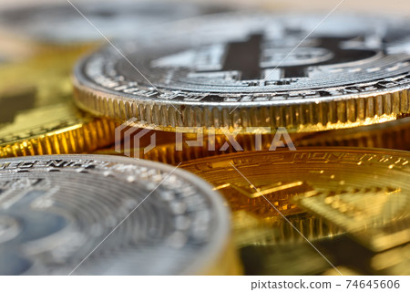 Silver and golden cryptocurrency bitcoin coins. 74645606