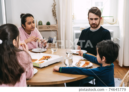 Multinational family eating lunch at home Multinational family eating lunch at home 74645779