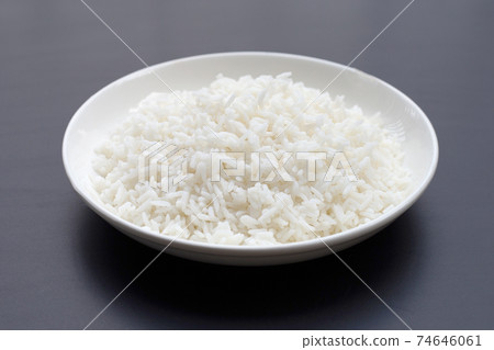 Dish of rice on dark background. Dish of rice on dark background. 74646061