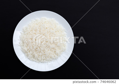 Dish of rice on dark background. Dish of rice on dark background. 74646062