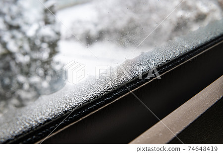 Condensation on highly insulated windowpanes on a snowy morning Condensation on highly insulated windowpanes on a snowy morning 74648419