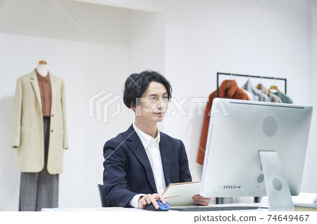 Fashion designer working in the office Fashion designer working in the office 74649467