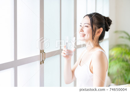 A young woman rehydrating A young woman rehydrating 74650004