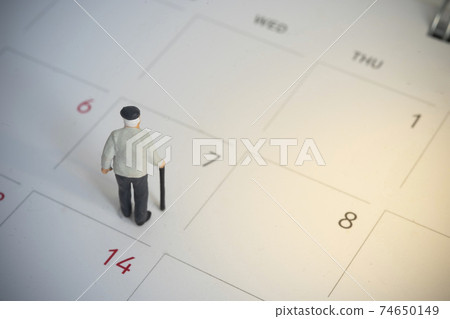 Elder man standing on World Health Day calendar Elder man standing on World Health Day calendar 74650149