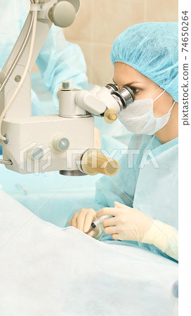 Ophthalmology laser microscope operation. Doctor in clinic. Patient eye treatment. Myopia and cataract removal Ophthalmology laser microscope operation. Doctor in clinic. Patient eye treatment. Myopia and cataract removal 74650264