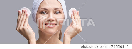 Cosmetology face cleaning. Female portrait. White cotton pad 74650341
