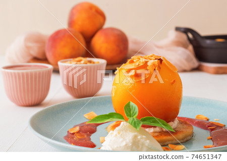 Roasted Peaches, tasty fresh fruit dessert with lemon, lime and basil creme fraiche and raspberry coulis. Roasted Peaches, tasty fresh fruit dessert with lemon, lime and basil creme fraiche and raspberry coulis. 74651347