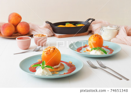 Roasted Peaches, tasty fresh fruit dessert with lemon, lime and basil creme fraiche and raspberry coulis. Roasted Peaches, tasty fresh fruit dessert with lemon, lime and basil creme fraiche and raspberry coulis. 74651348