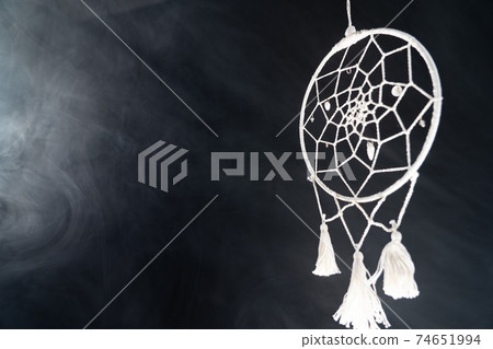 Mystical attribute dreamcatcher on a black background with smoke Mystical attribute dreamcatcher on a black background with smoke 74651994