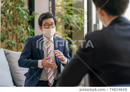 A businessman who can't convey his thoughts through a mask A businessman who can't convey his thoughts through a mask 74654649