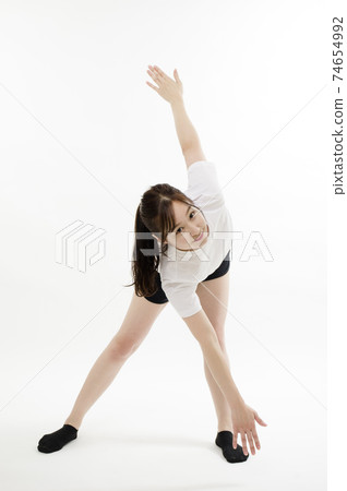 A young woman doing flexible exercises using her whole body 74654992