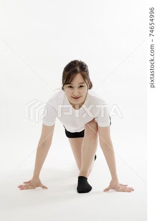 Young woman doing gymnastics 74654996