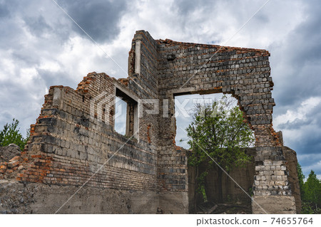 Destroyed wall. Fragments of the wall against the sky. Ruins of houses. Summer day Destroyed wall. Fragments of the wall against the sky. Ruins of houses. Summer day 74655764