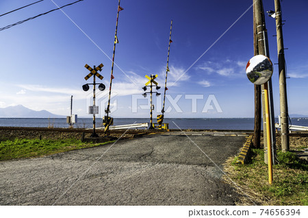 White clouds in the clear blue sky A crossing of the triangular line where you can see the blue sea of the Ariake Sea 74656394