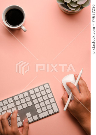 Male hands working with computer mouse and keyboard on creative workspace Male hands working with computer mouse and keyboard on creative workspace 74657256