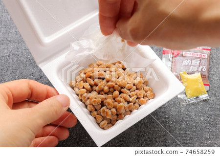 Women's hands peeling off the natto pack sheet Women's hands peeling off the natto pack sheet 74658259